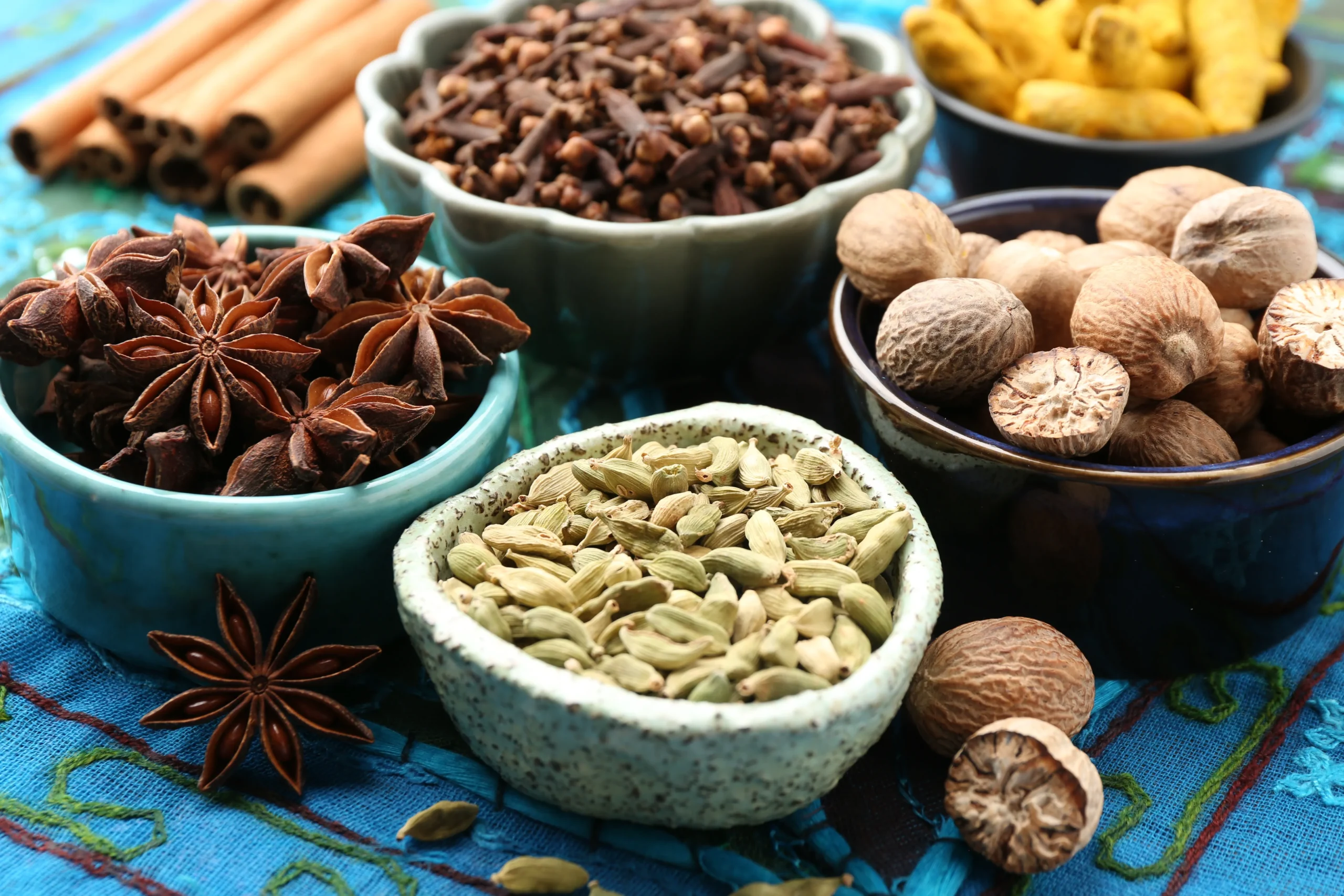 Assorted whole spices in bowls